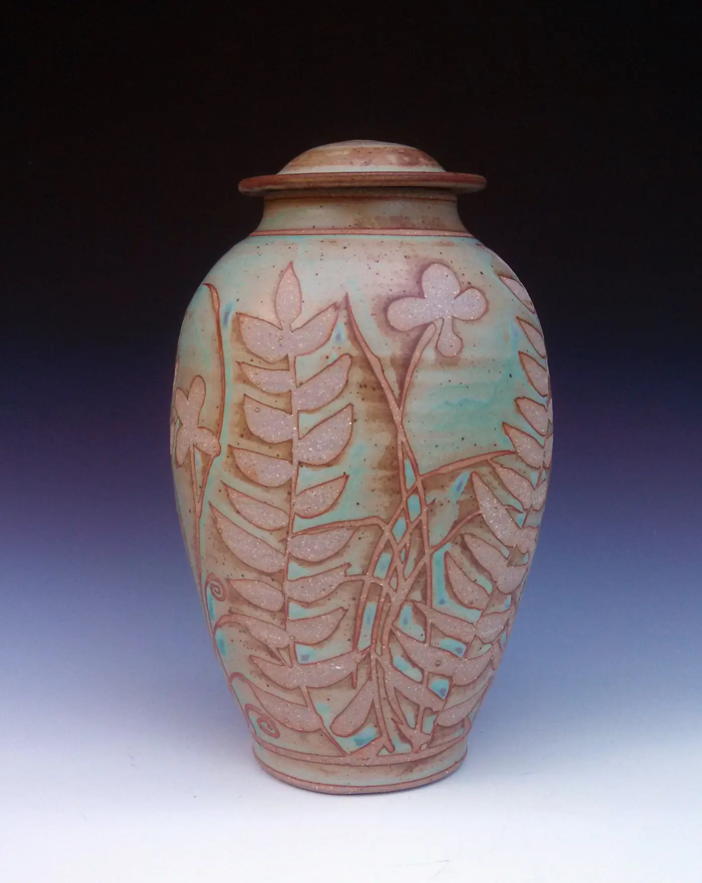 Large turquoise covered jar with carved leaves
