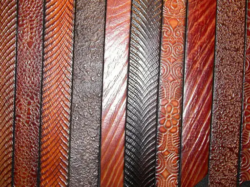 Tooled leather belts showing several hammered patterns